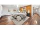 Stylish main bedroom featuring wood accent wall, light gray walls, and wood flooring at 6990 W 9Th Pl, Lakewood, CO 80214