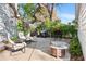 Backyard patio with outdoor seating, grill, and shade provided by mature trees at 6990 W 9Th Pl, Lakewood, CO 80214