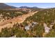 Panoramic aerial view of a home situated amongst a lush forest with mountains in the distance at 2122 Cramner Ct, Evergreen, CO 80439