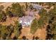 Aerial view showing a home with a deck nestled among mature trees at 2122 Cramner Ct, Evergreen, CO 80439