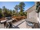 Well-maintained back deck with a grill and outdoor dining set, perfect for entertaining guests at 2122 Cramner Ct, Evergreen, CO 80439