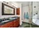 Elegant bathroom features double vanities, a glass shower, and a luxurious soaking tub at 2122 Cramner Ct, Evergreen, CO 80439