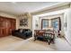 Inviting bedroom with a stylish bed frame, comfortable seating area, and a bright window for natural light at 2122 Cramner Ct, Evergreen, CO 80439