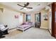 Comfortable bedroom featuring a ceiling fan, natural light, and charming decor at 2122 Cramner Ct, Evergreen, CO 80439