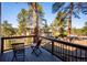 Inviting deck with chairs and scenic views of the surrounding trees and landscape at 2122 Cramner Ct, Evergreen, CO 80439