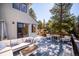 Exterior deck provides ample seating, dining space, and wooded views of the surrounding landscape at 2122 Cramner Ct, Evergreen, CO 80439