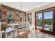 Dining area with rustic wood accents and views of the surrounding forest at 2122 Cramner Ct, Evergreen, CO 80439