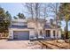 Charming home with stone accents, well-maintained landscaping, and a two-car garage offers curb appeal at 2122 Cramner Ct, Evergreen, CO 80439