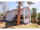 Back exterior view of house featuring a deck, many windows, and surrounding trees at 2122 Cramner Ct, Evergreen, CO 80439
