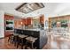 Chef's kitchen with stainless appliances, granite countertops, island with bar seating, and wood beam ceiling at 2122 Cramner Ct, Evergreen, CO 80439