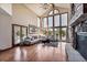Spacious living room with vaulted ceilings, large windows offering natural light, and a stone fireplace at 2122 Cramner Ct, Evergreen, CO 80439