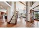 Open floor plan showcases a living room with vaulted ceilings, stone fireplace, and staircase at 2122 Cramner Ct, Evergreen, CO 80439