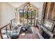 Spacious living room with soaring ceilings, large windows, and a stone fireplace at 2122 Cramner Ct, Evergreen, CO 80439