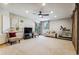 Spacious recreation room with a ceiling fan, windows, and comfortable seating at 2122 Cramner Ct, Evergreen, CO 80439