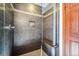 Modern bathroom shower with sleek gray tiles and a built-in bench at 2122 Cramner Ct, Evergreen, CO 80439