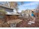 Backyard garden with wooden shed, raised garden beds, and stone pathway at 1623 Dayton St, Aurora, CO 80010