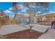 Backyard patio with patio furniture, mature shade tree, and privacy fencing at 1623 Dayton St, Aurora, CO 80010