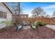 Backyard with wooden fence and fire pit, offering a cozy outdoor space for entertaining and relaxation at 1623 Dayton St, Aurora, CO 80010