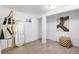 Finished basement area featuring neutral carpeting, exposed beams, and a storage area at 1623 Dayton St, Aurora, CO 80010