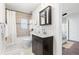 Cozy bathroom with tiled shower/tub combo, dark vanity, and mirrored medicine cabinet at 1623 Dayton St, Aurora, CO 80010