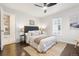 A bright bedroom features a ceiling fan, stylish decor, and a window letting in natural light at 1623 Dayton St, Aurora, CO 80010