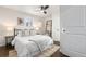 Bright bedroom features a ceiling fan, dark wood floors, and decor shelving unit at 1623 Dayton St, Aurora, CO 80010