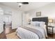 Bright bedroom has a comfortable bed, dark wood floors, and a glimpse into a sunlit room at 1623 Dayton St, Aurora, CO 80010