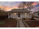 Charming home featuring a covered porch, solar panels, and a meticulously landscaped front yard at 1623 Dayton St, Aurora, CO 80010