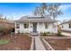 Charming home featuring a covered porch, solar panels, and a meticulously landscaped front yard at 1623 Dayton St, Aurora, CO 80010