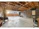 An oversized garage with abundant space, featuring exposed rafters, a sunlit door, and plentiful storage at 1623 Dayton St, Aurora, CO 80010