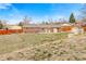 Spacious backyard featuring a small shed, mature trees and a fence with lots of potential at 7162 Quay St, Arvada, CO 80003