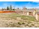 Spacious backyard featuring a small shed, mature trees and a fence with lots of potential at 7162 Quay St, Arvada, CO 80003