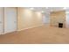 Unfinished basement space with neutral carpet flooring and stone accent wall at 7162 Quay St, Arvada, CO 80003