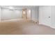 Spacious basement featuring neutral carpeting, stone accent wall, and access to storage at 7162 Quay St, Arvada, CO 80003