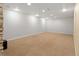 Unfinished basement with neutral carpet, bright lighting, and a contemporary aesthetic at 7162 Quay St, Arvada, CO 80003