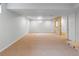 Large unfinished basement space with neutral carpet, window, and stone accent wall at 7162 Quay St, Arvada, CO 80003