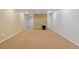 Unfinished basement space with neutral carpet flooring and stone accent wall at 7162 Quay St, Arvada, CO 80003