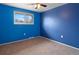 A blue bedroom featuring carpet and a window at 7162 Quay St, Arvada, CO 80003