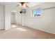 Bright bedroom features a mirrored closet, ceiling fan, and window at 7162 Quay St, Arvada, CO 80003