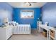 Comfortable bedroom with light blue walls, carpet, and a window view at 7162 Quay St, Arvada, CO 80003