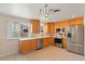 Spacious kitchen with stainless steel appliances, wood cabinets and tile flooring at 7162 Quay St, Arvada, CO 80003