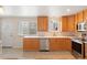 Bright kitchen featuring wood cabinets, stainless steel appliances, and a window with a view at 7162 Quay St, Arvada, CO 80003