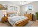 Comfortable main bedroom with a wooden bed frame, dresser, and windows at 7162 Quay St, Arvada, CO 80003
