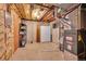 Unfinished basement featuring mechanical components such as a furnace, hot water heater and storage shelving at 4734 S Garland St, Littleton, CO 80123