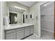 Bathroom with large vanity, ample lighting, and walk-in closet at 4734 S Garland St, Littleton, CO 80123