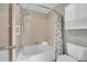 Bathroom featuring a tub, shower, tile surround, and vanity storage at 4734 S Garland St, Littleton, CO 80123