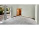 Bedroom featuring light green walls, carpeting, and sliding glass doors to a deck at 4734 S Garland St, Littleton, CO 80123