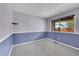 Bedroom with a blue accent wall, neutral carpet, and bright window at 4734 S Garland St, Littleton, CO 80123