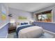 Bedroom with a comfortable queen bed, large window, and serene blue accents at 4734 S Garland St, Littleton, CO 80123