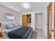 Bedroom with a plush bed, closet with wood doors, and a window at 4734 S Garland St, Littleton, CO 80123